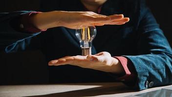 hand holding light bulb. idea concept with innovation and inspiration photo
