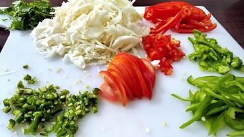 Top view of Chopped vegetables on white chopper photo