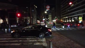 night view of the street with beautiful light illumination decoration on tree in Ginza area with some traffic and pedestrian video