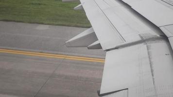 view from inside cabin of airplane aircraft while taxing on taxi way in the airport video