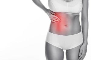 Woman is feeling pain under her ribs photo