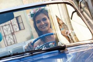 Beautiful woman driving a retro convertible car photo