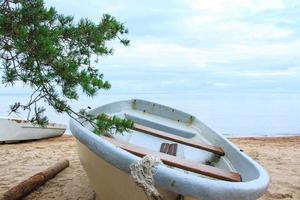 Closeup shot of abandoned fishing boats on sandy beach. photo