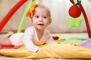 Cute baby is playing on the activity mat photo