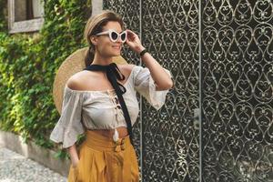 Young woman walking by the streets of small Italian town photo