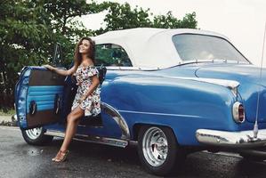 Beautiful woman driving a retro convertible car photo