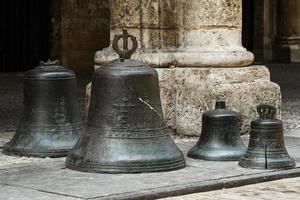 Old broken church bells on the ground photo