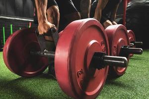 Male hands with a weights for farmer's walk exercise photo