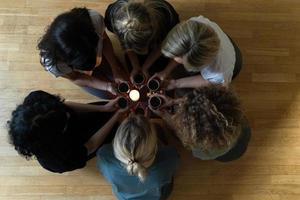 Women friends holding cups of hot tea. photo