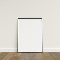 Empty picture frame on wooden floor leaning against wall. Blank poster frame standing on wooden floor. Blank poster frame mockup. Empty picture frame mockup. 3d rendering. photo