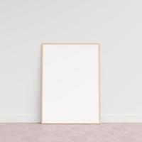 Empty picture frame on wooden floor leaning against wall. Blank poster frame standing on wooden floor. Blank poster frame mockup. Empty picture frame mockup. 3d rendering. photo