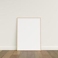 Empty picture frame on wooden floor leaning against wall. Blank poster frame standing on wooden floor. Blank poster frame mockup. Empty picture frame mockup. 3d rendering. photo