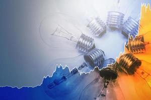 Light bulbs and rising chart representing current electricity price during energy crisis in the world photo
