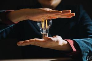 hand holding light bulb. idea concept with innovation and inspiration photo