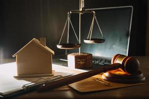 Business and lawyers discussing contract papers with brass scale on desk in office. Law, legal services, advice, justice and law concept picture with film grain effect photo