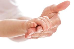 Close up of little baby holding father's hand photo