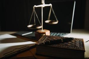 Business and lawyers discussing contract papers with brass scale on desk in office. Law, legal services, advice, justice and law concept picture with film grain effect photo