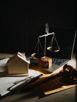 Business and lawyers discussing contract papers with brass scale on desk in office. Law, legal services, advice, justice and law concept picture with film grain effect photo