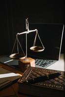 Business and lawyers discussing contract papers with brass scale on desk in office. Law, legal services, advice, justice and law concept picture with film grain effect photo