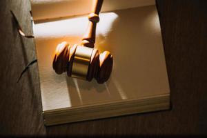 Business and lawyers discussing contract papers with brass scale on desk in office. Law, legal services, advice, justice and law concept picture with film grain effect photo