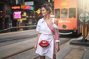 Stylish woman walking along the street of Hong Kong city photo