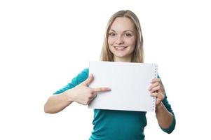 young blonde woman pointing to blank sign photo