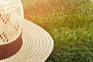 Straw hat on the grass. Summer time. photo