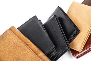 Stack of different wallets on white background photo