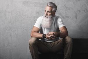 Handsome bearded senior man posing in studio photo