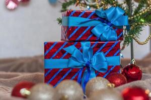 Holiday gifts with blue bows under the tree. Christmas and New year. photo