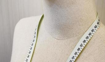 Close up mannequin with waist measuring tape photo