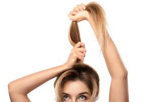 Beautiful woman is very happy of her hair growth progress photo