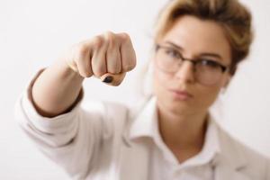 Confident business woman make a punch into the camera photo