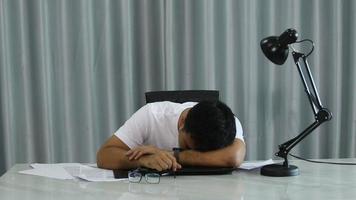 Stressed overwhelmed young businessman in suit working on computer, suffering from eyes fatigue or having painful feelings video