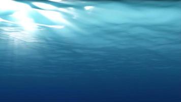 Underwater light filters down through blue water - Loop video