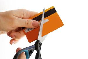 Woman cutting her credit card with a scissors photo