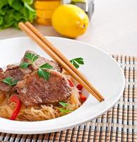 Pork medallions in oyster sauce with noodles photo