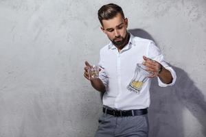 Handsome bearded man with a glass of whiskey photo