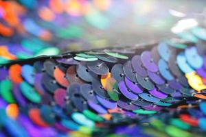 Closeup shot of a shiny multicolored sequin fabric. photo