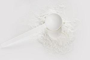 Scoop with creatine monohydrate supplement photo