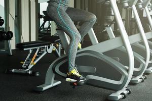 Woman on stationary bike in the gym photo