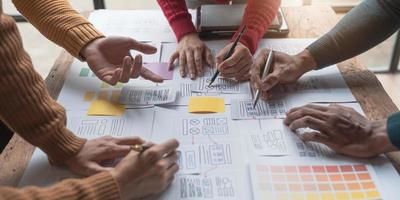UI UX creative designer team designing wireframe layout for responsive mobile smartphone application in office photo