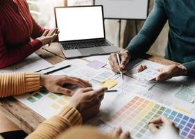 Team ux designer creative graphic planning application development a prototype smartphone layout. photo