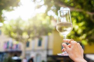 Hand with a glass of white wine photo