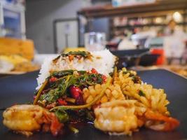 Spicy seafood with Jasmine rice in grey dish on wooden table photo