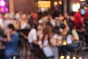 blurred image at the restaurant night time, many people in the restaurant eat and party happy relaxing photo