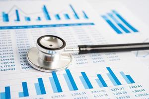 Stethoscope on charts and graphs paper, Finance, Account, Statistics, Investment, Analytic research data economy and Business company concept. photo