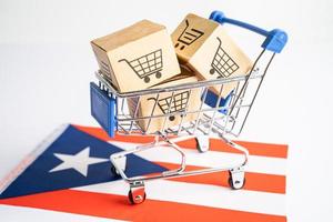 Box with shopping cart logo and Puerto Rico flag, Import Export Shopping online or eCommerce finance delivery service store product shipping, trade, supplier concept. photo