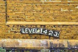 Detailed view at a colorful old and weathered brick wall texture as a panoramic background. photo