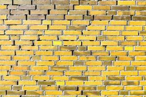 Detailed view at a colorful old and weathered brick wall texture as a panoramic background. photo